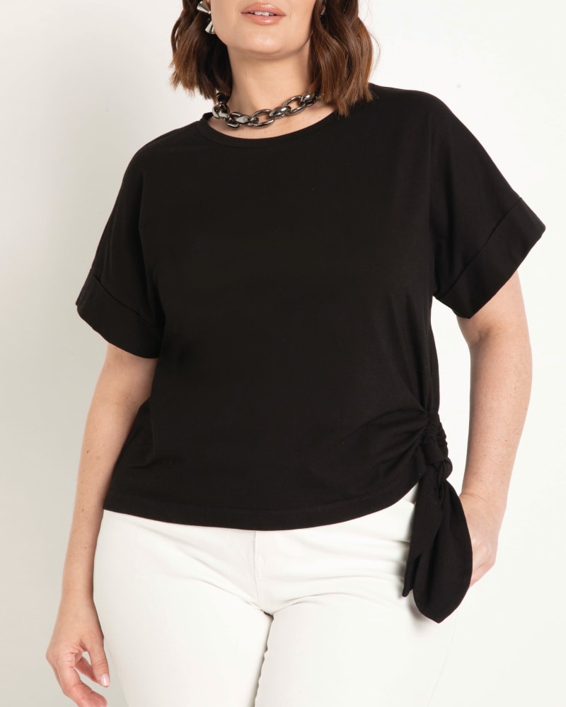 Front of a model wearing a size 14|16 Isabella Tie Side Tee in Totally Black by ELOQUII. | dia_product_style_image_id:204004